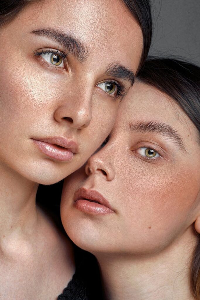 A detailed close-up portrait showcasing two women with radiant and healthy skin, emphasizing beauty and skincare.