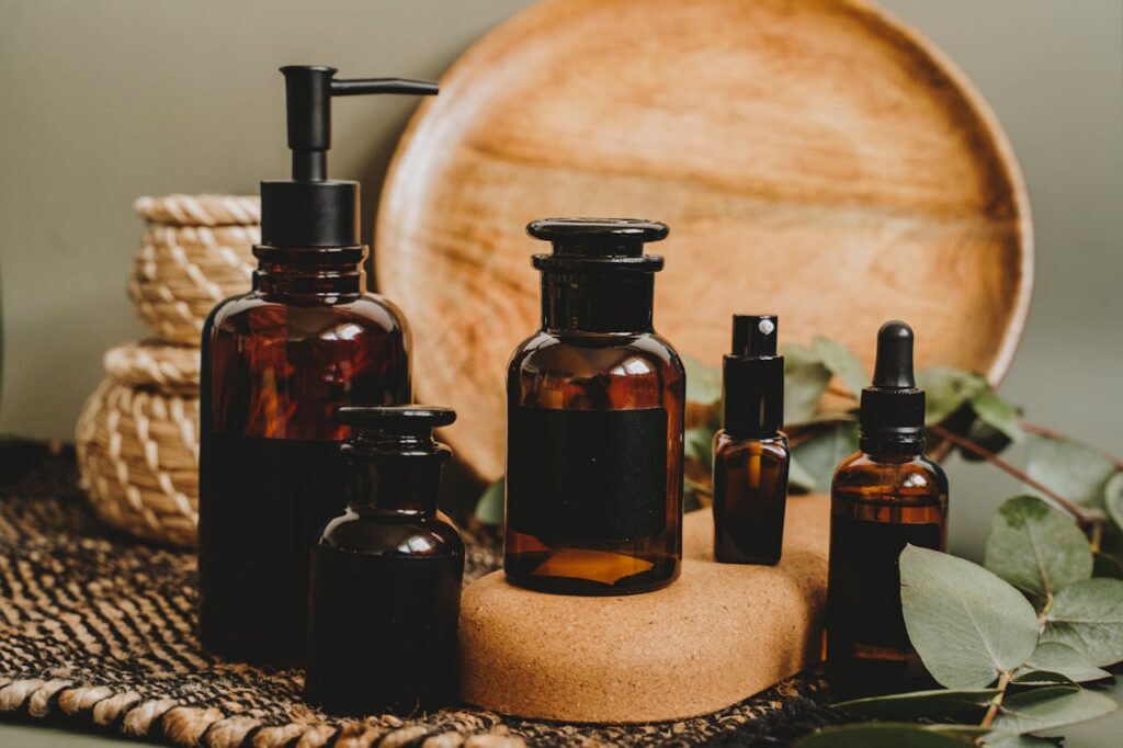 Aesthetic arrangement of amber glass bottles with a rustic backdrop, perfect for beauty product showcasing.